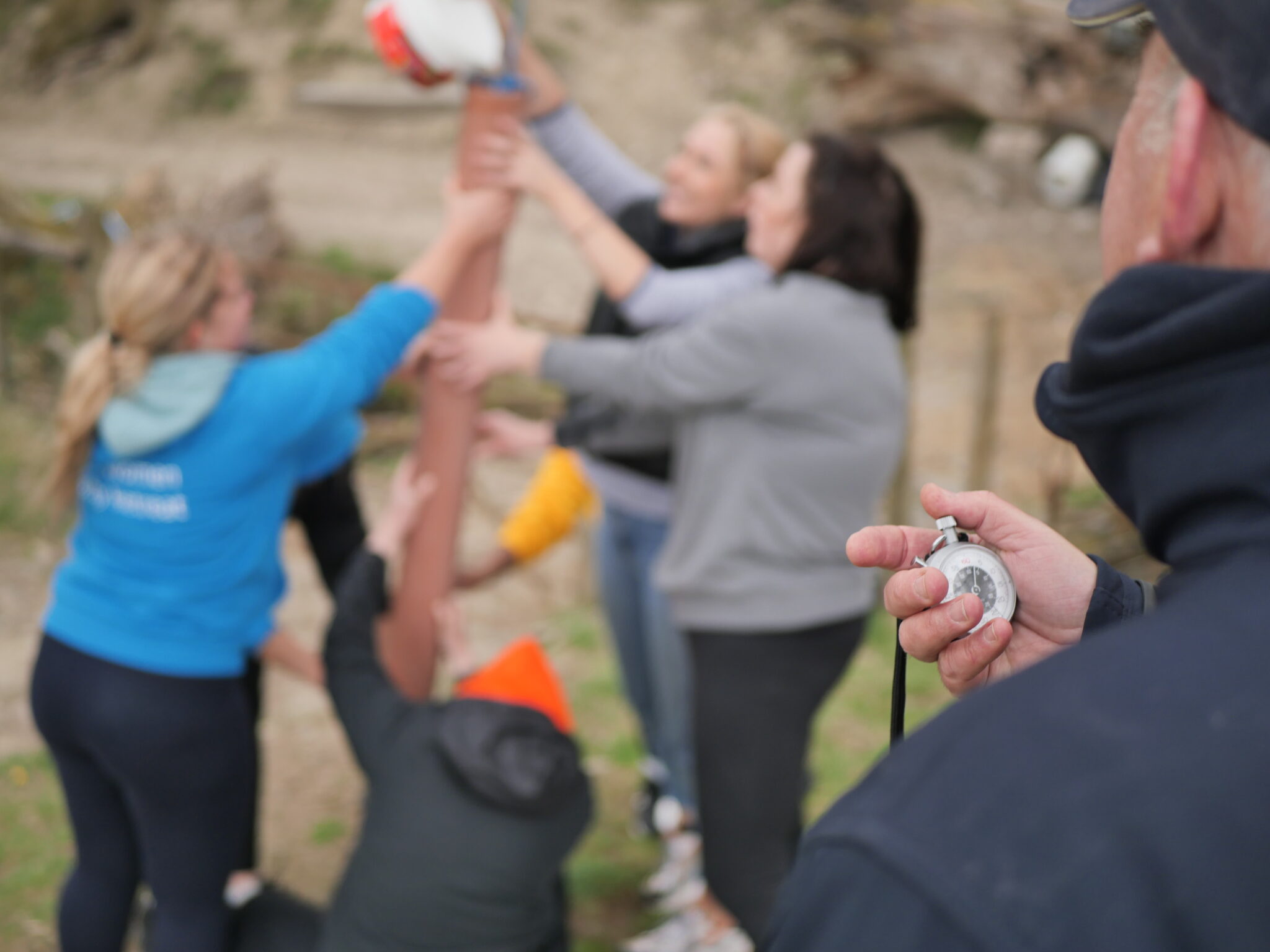 A group taking part in an outdoor team challenge in Wales
